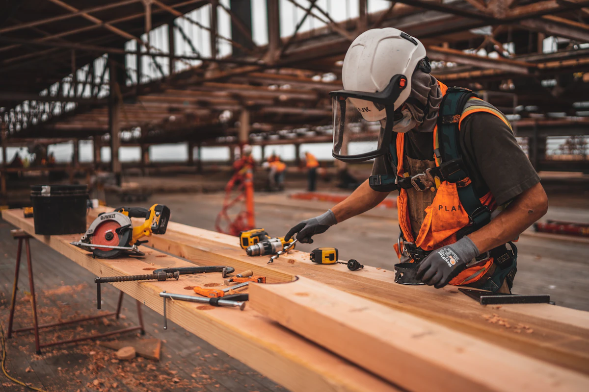 Professional construction tradesperson measuring and installing drywall framing on site
